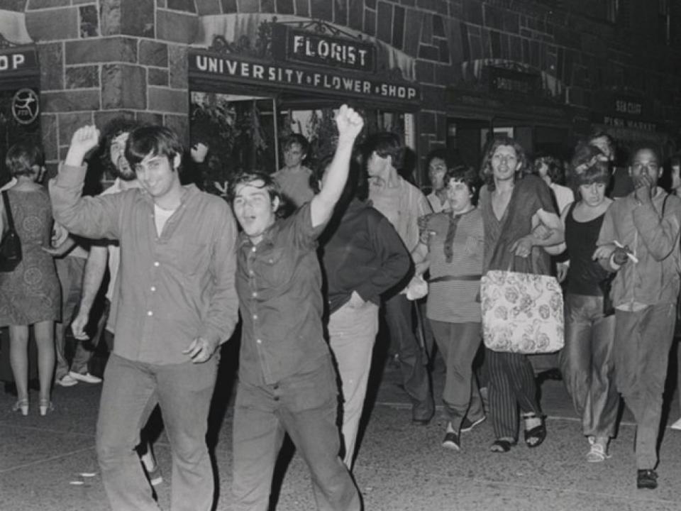 Gay Liberation Front members Jerry Hoose (left), Mark Segal (right), and Sylvia Rivera (background, holding a bag) at a GLF demonstration against New York University. (Photo: Diana Davies collection, New York Public Library).